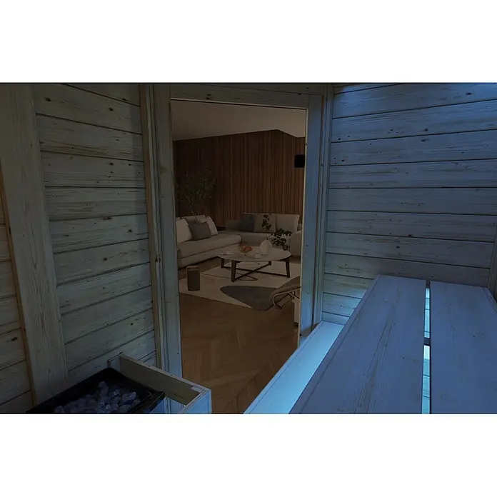 Karibu Elementsauna Oda Eck - Mit Ofen, L x B x H: 145 x 148 x 190,5 cm - Holzsauna-Interieur mit Ofen, Blick in ein modernes Wohnzimmer mit Sofa, Couchtisch und Holzverkleidung.