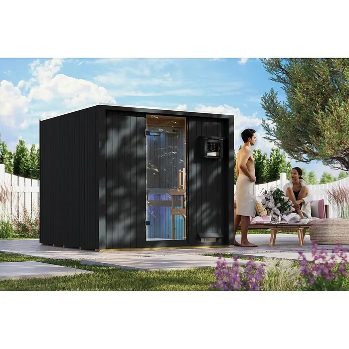 Karibu Saunahaus Tim - Ohne Ofen, Schwarz, L x B x H: 224 x 219,5 x 196 cm - Schwarze Außensauna mit Glastür im Gartenambiente, Personen entspannen in der Nähe.