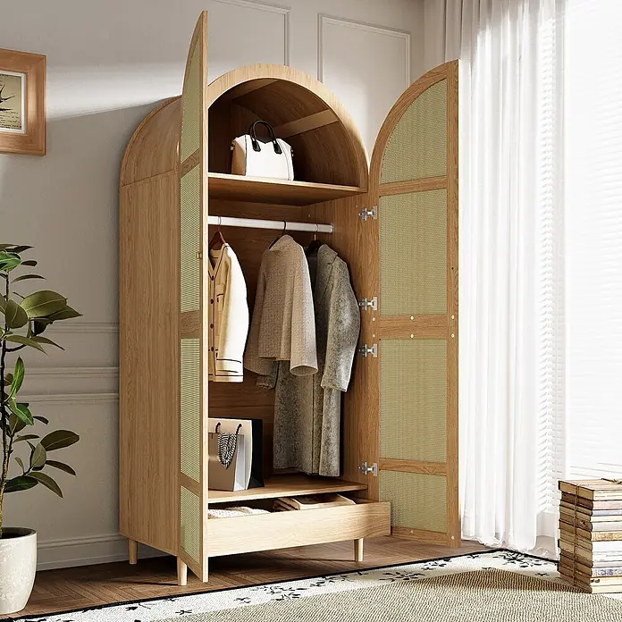 SONNENH Kleiderschrank mit Bogentüren und Rattangeflecht, Natur -  - Offener Kleiderschrank aus hellem Holz mit gewölbten Rattan-Türen, mit Kleidung und Tasche. In einem Wohnambiente.
