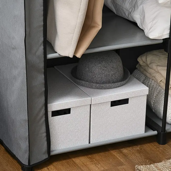 SONNENH Kleiderschrank - Hellgrau - Helles graues Stoff-Kleiderschrank-Interieur mit zwei Aufbewahrungsboxen, einem grauen Filzhut und gefalteten Textilien.