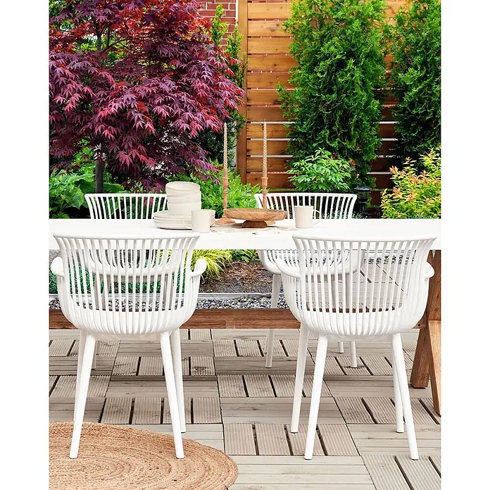 4er-Set Esszimmerstuhl PESARO in Weiß -  - Weiße Lattenstühle umgeben einen Holztisch für Mahlzeiten auf der Terrasse.