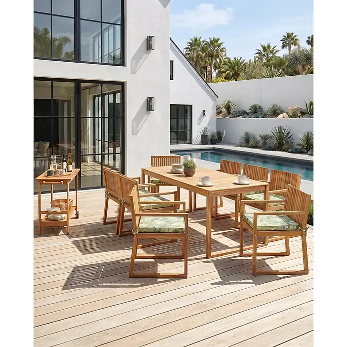 Beliani Gartenstuhl-Set SASSARI II - 8 Stk., zertifiziertes Akazienholz, Braun, B x T x H: 54 x 59 x 80 cm - Outdoor-Essgruppe aus Holz mit Tisch und Stühlen mit gemusterten Kissen, sowie passendem Servierwagen, auf einer Terrasse am Pool.
