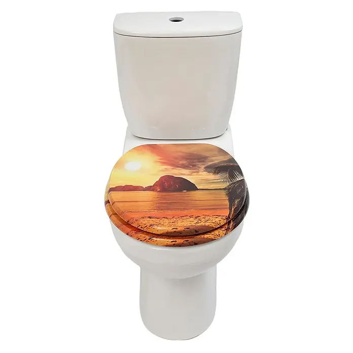 SAINOS WC-Sitz MDF WC-Sitz, Orange, Universal-O-Form, Absenkautomatik, Unten - MDF, Orange, Mit Absenkautomatik - Weiße Keramiktoilette mit Deckel, der einen lebhaften Sonnenuntergang am Strand mit Meer, Insel und Palme zeigt.