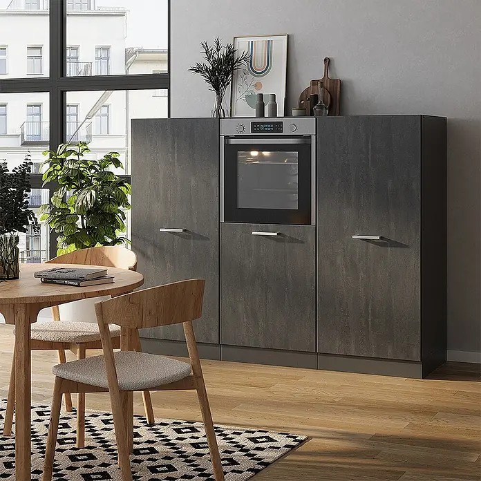 Vicco Küchenleerblock R-Line Schwarz Beton/Anthrazit ohne Arbeitsplatte - Schwarz Beton - Dunkelgraue Küchenschrankeinheit mit integriertem Backofen und silbernen Griffen in einem modernen Esszimmer.