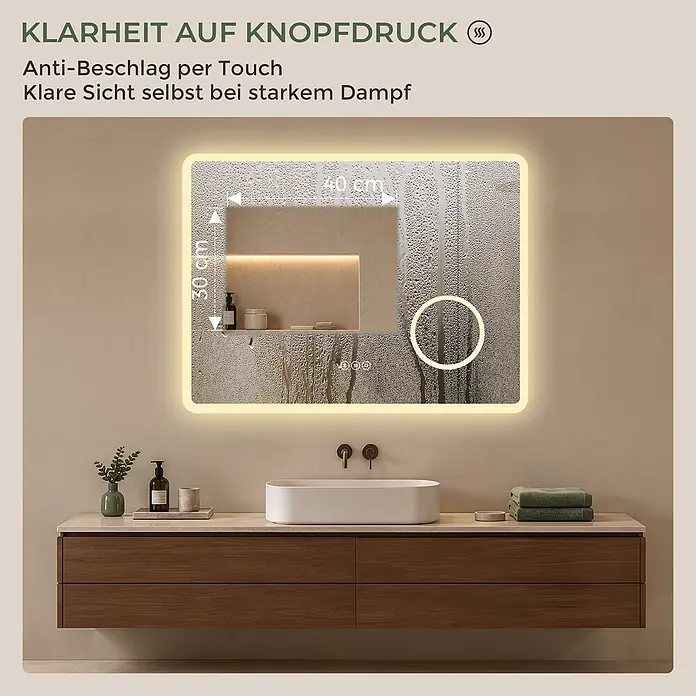 Badspiegel LED 80 x 60 cm, Bluetooth, 3-fach Vergrößerung, Anti-Beschlag -  - Beleuchteter Badezimmerspiegel mit Antibeschlagfunktion, zeigt einen klaren Bereich trotz Dampf, über einem Waschtisch montiert.