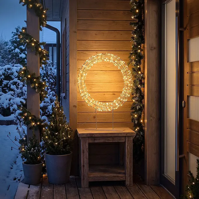 ECD Germany LED-Weihnachtsdekofigur Weihnachtskranz 53 cm Weihnachtsbeleuchtung Timer 300 LED Warmweiß - 38 x 8 x 53 cm, Warmweiß, Netzbetrieben, LED - Beleuchteter warmweißer LED-Weihnachtskranz auf einem Ständer, der eine festliche Außenterrassenszene beleuchtet.