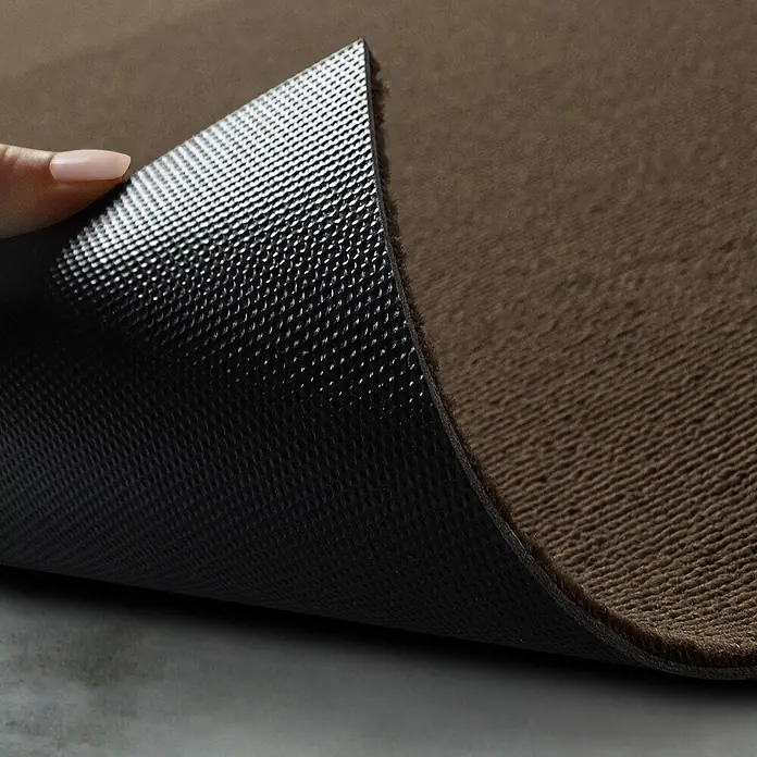 Floordirekt Teppichfliese Lyonn Braun 50 x 50 cm 0,25 m² -  - Braune Matte, eine Ecke wird angehoben, um die schwarze, texturierte Anti-Rutsch-Unterseite zu zeigen.