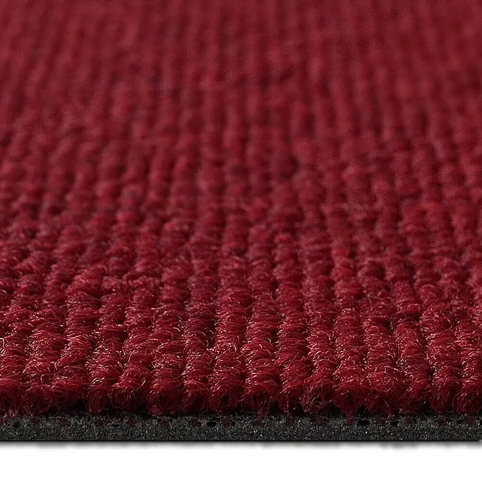 Floordirekt Teppichfliese Lyonn - 50 x 50 cm - 0,25 m² - Rot -  - Nahaufnahme einer roten gerippten Teppichmatte mit schwarzer Unterseite.