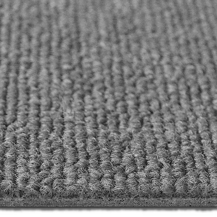Floordirekt Teppichfliese Lyonn - 50 x 50 cm - 0,25 m² - Hellgrau -  - Nahaufnahme eines grauen gerippten Teppichs oder einer Fußmatte mit Schlingenstruktur und sichtbarer Kante.