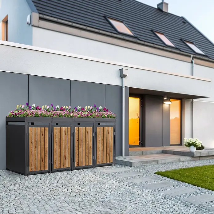 ML-Design 4x Mülltonnenbox 240L Pflanzdach Anthrazit-Holzoptik 260x80x124cm -  - Drei schwarze Metall- und Holzpaneel-Gartenboxen mit integrierten Blumenkästen voller bunter Blumen, vor einem modernen Haus.