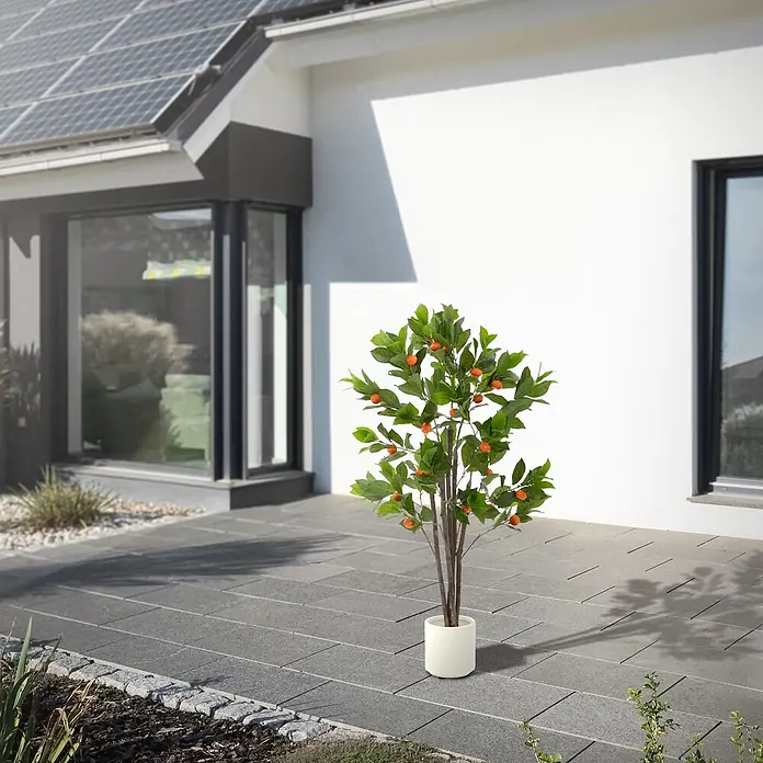 Kunstpflanze Orangenbaum 130 cm aus Kunststoff -  - Falscher Orangenbaum mit grünen Blättern und orangefarbenen Früchten in einem weißen Topf auf einer Terrasse.