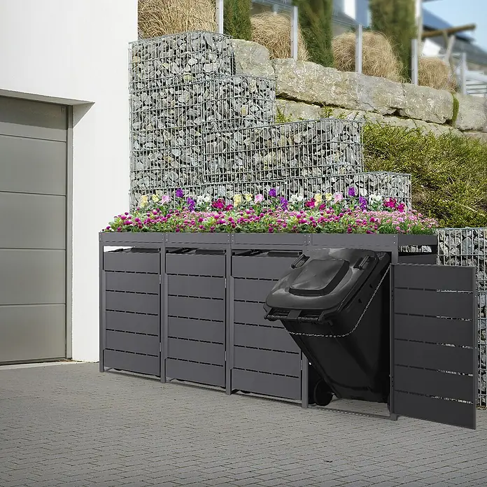 Mülltonnenbox 4er mit Pflanzdach 240L 260x80x124cm Anthrazit aus Stahl -  - Dunkelgraue Mülltonnenbox aus Metall mit integriertem Pflanzgefäß, beherbergt drei Behälter, einer davon halb ausgefahren.
