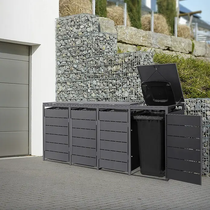 Mülltonnenbox 4er 240L 260x80x120 cm Anthrazit aus Stahl wetterfest -  - Dunkelgraue Mülltonnenbox aus Metall mit drei Fächern. Ein Fach ist offen mit schwarzer Tonne und Deckel, draußen auf Pflaster.