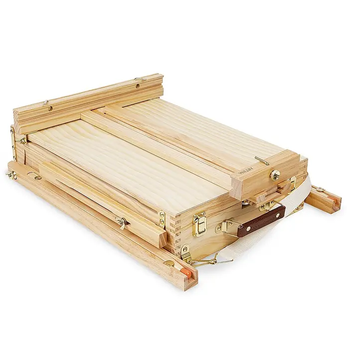 Artina Acrylfarben-Set inklusive Staffelei + 5 Pinsel + 2 Leinwände +3 Malspachtel -  - Zusammengeklappter Staffeleikoffer aus hellem Holz mit Messingverschlüssen und Griff, transportbereit.