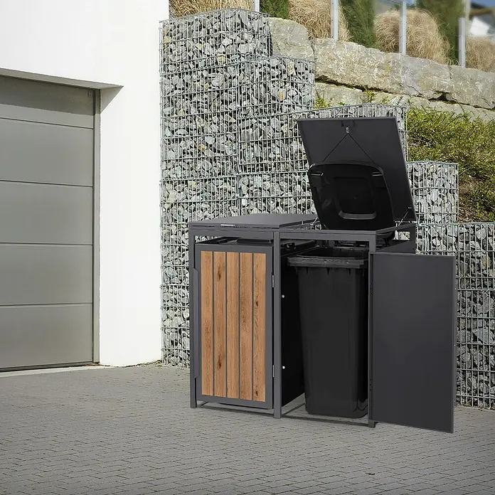 ML-Design Mülltonnenbox 2er 240L 132x80x120 cm Anthrazit-Holzoptik Müllbox -  - Mülleimerbox aus dunkelgrauem Metall und Holz mit zwei Fächern auf gepflastertem Außenbereich, mit offener Klappe und Tür, die schwarze Behälter zeigen.