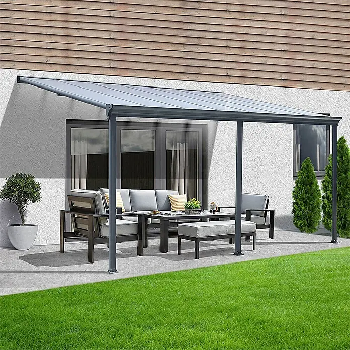 HOME DELUXE - Terrassenüberdachung SOLIS | Farbe: Grau, Größe: 557 / 564 x 303 / 300 x 278 / 226 cm -  - Dunkelgraue Aluminium-Terrassenüberdachung mit transparenten Dachpaneelen, schützt eine Sitzgruppe im Freien.