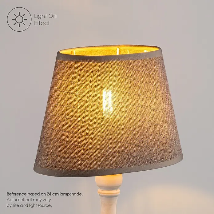 Home Sweet Home Lampenschirm Melrose - Ø x H: 14 x 16 cm, Hellgrau, Stoff, Oval - Ein grauer Stoff-Lampenschirm leuchtet von innen mit warmem Licht.