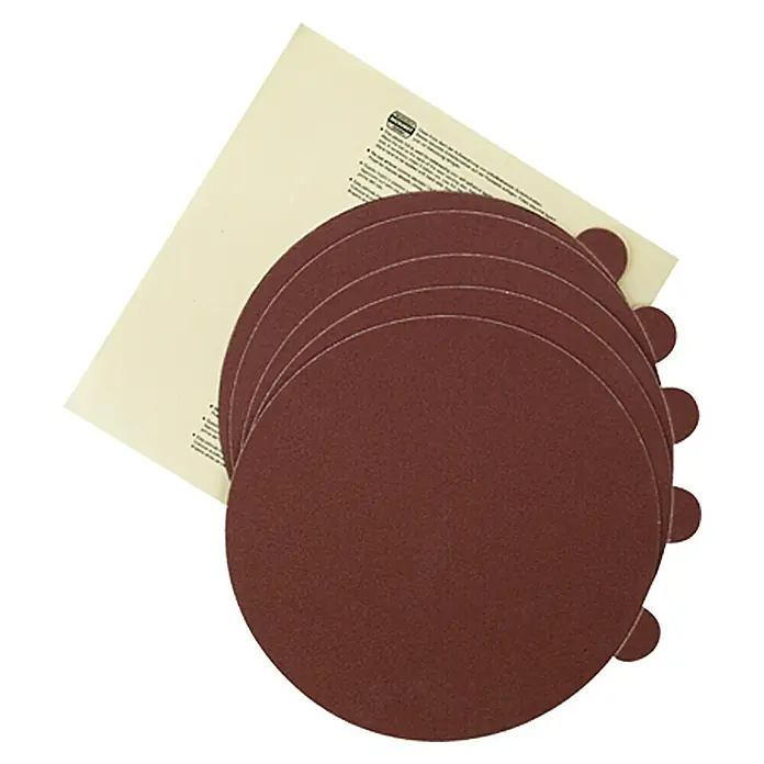 Proxxon Schleifscheiben No 28164 - 125 mm, Körnung: 240 - Nahaufnahme von Schleifscheiben, die gestapelt und von einer Papierunterlage teilweise bedeckt sind, ideal zum Schleifen und Polieren.