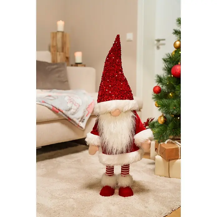 Dekofigur Weihnachtswichtel schaukelnd - L x B x H: 33 x 33 x 83 cm, Polyester - Weihnachtswichtel mit rotem Paillettenhut, weißem Kunstfellbart, rotem Körper und gestreiften Beinen, stehend als festliche Dekoration.