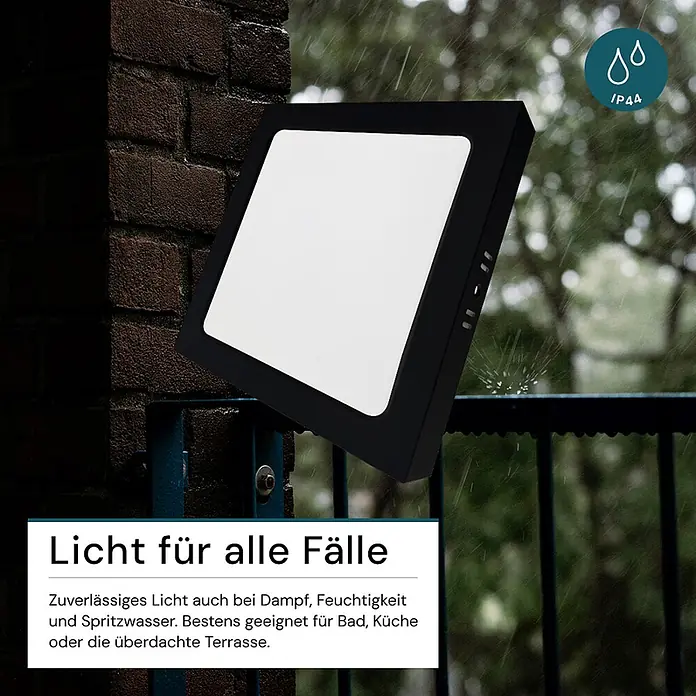 Luxula LED-Wand- & Deckenleuchte Aufbauleuchte 12W IP44-Geschützt 1200lm -  - Schwarze, quadratische Leuchte (IP44), spritzwassergeschützt, an einer Wand im Regen montiert. Ideal für feuchte Umgebungen.