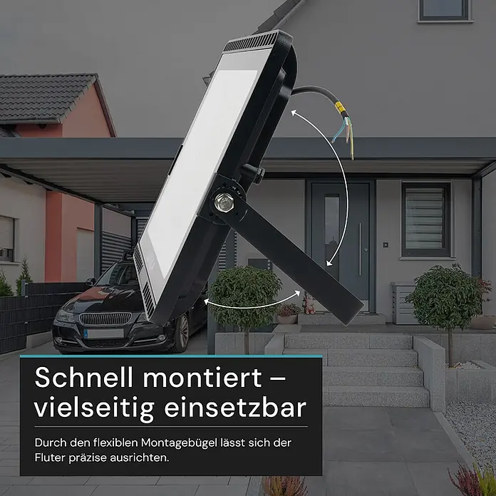 Luxula LED-Strahler - 200 W, 20.000 lm, IP65 - Schwarzer LED-Fluter mit flexiblem Montagebügel zur präzisen Ausrichtung, draußen vor einem Haus platziert.