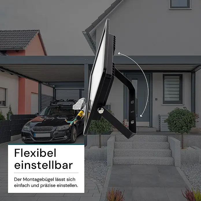 Luxula LED-Strahler - 30 W, 3.000 lm, 4.000 K, IP65 - Schwarzer Flutlichtstrahler mit verstellbarem Montagebügel, draußen vor einem Haus.