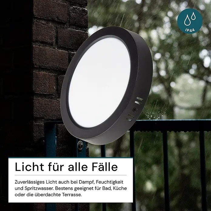 Luxula LED-Wand- & Deckenleuchte Aufbauleuchte 6W IP44-Geschützt 600lm -  - Runde schwarze LED-Leuchte mit weißem Diffusor, im Regen gezeigt, weist auf IP44 Spritzwasserschutz für Nassbereiche hin.