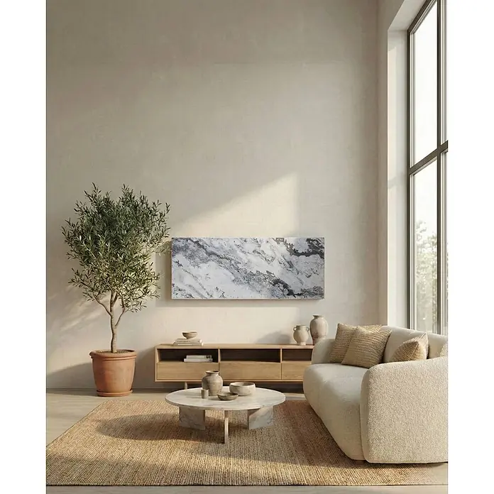 Marwona Qarama Infrarotheizung 800 W inkl. Funk-Thermostat -  - Ein neutrales, helles Wohnzimmer mit modernem Sofa, rundem Marmorcouchtisch und Holzkonsole, akzentuiert durch einen Olivenbaum.