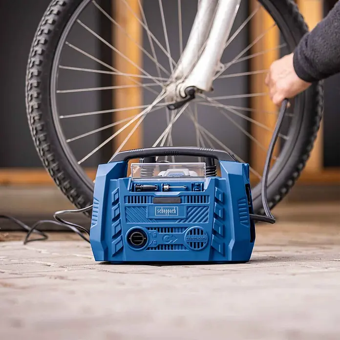 Scheppach IXES 20V Hybrid-Kompressor Air Force 6 - 20 V, Ohne Akku, Max. Druck: 10,3 bar - Blauer Scheppach Luftkompressor pumpt einen Fahrradreifen auf.