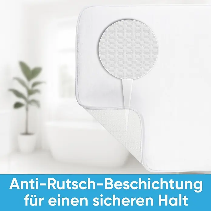 SANILO Badteppich Greego 50 x 80 cm - 50 x 80 cm, Polyester, Grün - Weiße Badematte mit Detailansicht der rutschfesten Beschichtung, vor verschwommenem Badezimmerhintergrund.