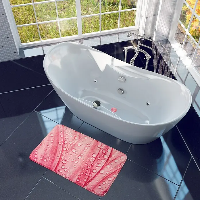 SANILO Badteppich Rosa Flower 50 x 80 cm - 50 x 80 cm, Polyester, Rosa - Rosa Badematte mit Wassertropfenmuster, auf dunklem Fliesenboden neben einer weißen Badewanne platziert.