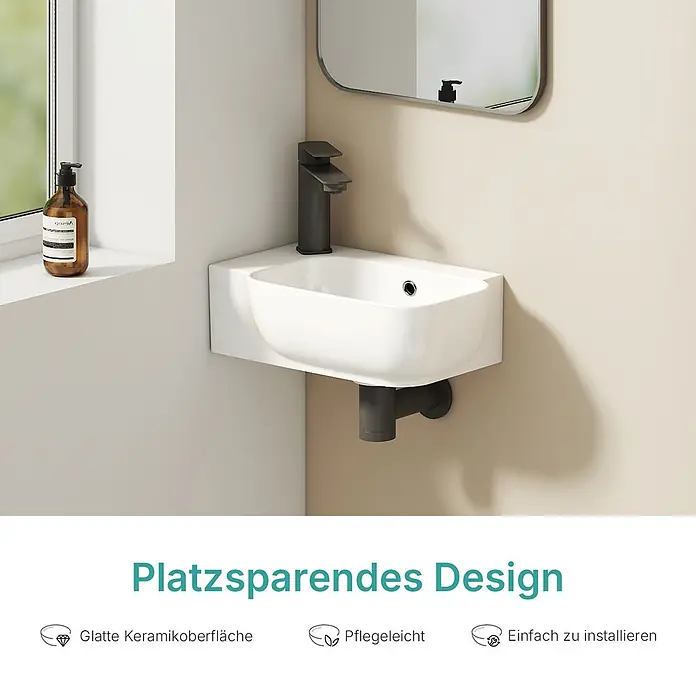 Wandwaschbecken Ceraform CB23 -  - Platzsparendes weißes Keramik-Eckwaschbecken mit dunkler Armatur, an der Wand montiert.