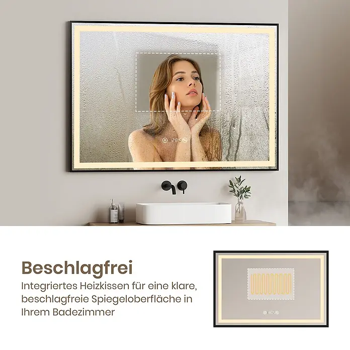 Emke Lichtspiegel Frolite LM23 -  - Rechteckiger LED-Badspiegel mit Antibeschlagfunktion, die einen klaren Bereich auf der beschlagenen Oberfläche zeigt, eine Person spiegelnd. Ein Einsatz zeigt das Heizkissen.