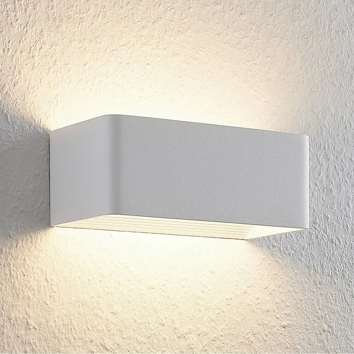 Arcchio LED Wandleuchte innen in weiß, Wandlampe -  - Rechteckige weiße LED-Wandleuchte, die warmes Licht nach oben und unten auf eine strukturierte Wand wirft.