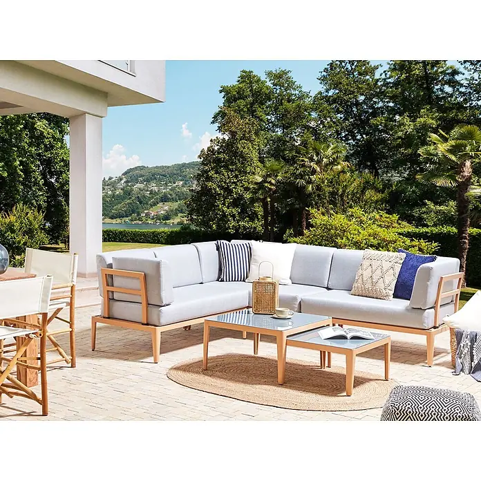 5-tlg Lounge Set RIMA in Grau/Braun linksseitig -  - Ein hellgraues Outdoor-Ecksofa mit Holzrahmen und passenden Glastischen auf einer Terrasse mit Blick auf See und Berge.