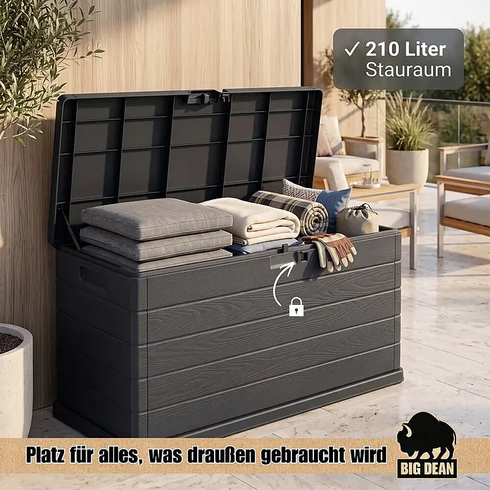 BigDean Kissenbox 210 Liter extra schmal für kleinere Balkone -  - Dunkelgraue Outdoor-Aufbewahrungsbox mit Holzoptik, geöffnet und gefüllt mit Kissen und Decken auf einer Terrasse. Bietet 210L Stauraum und eine Schließoption.