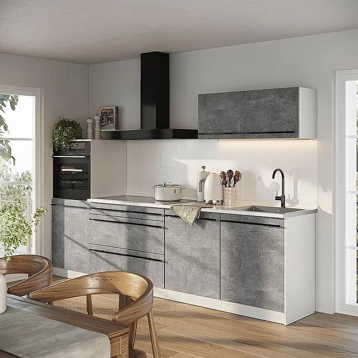 Küchenzeile R-Line 280 cm Beton Art.-Nr. 67270 -  - Moderne Küche mit grauen Betonoptik-Schränken, weißen Arbeitsplatten, einem schwarzen Backofen und einer Dunstabzugshaube.