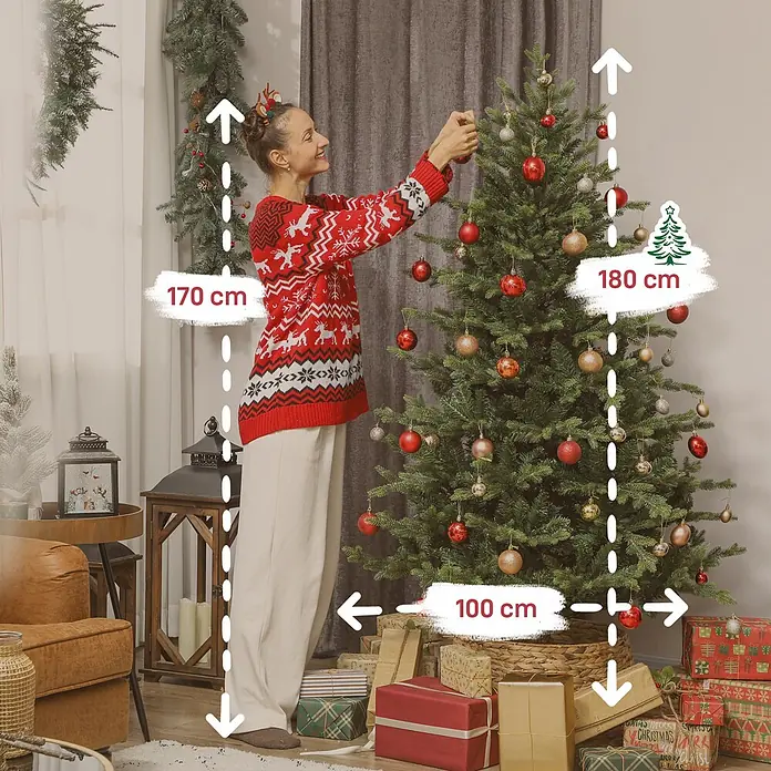 HOMCOM-Weihnachtsbaum-100L x 100B x 180H cm-Grün -  - Eine Frau schmückt einen 180 cm hohen, 100 cm breiten Weihnachtsbaum mit Kugeln in einem festlichen Wohnzimmer.