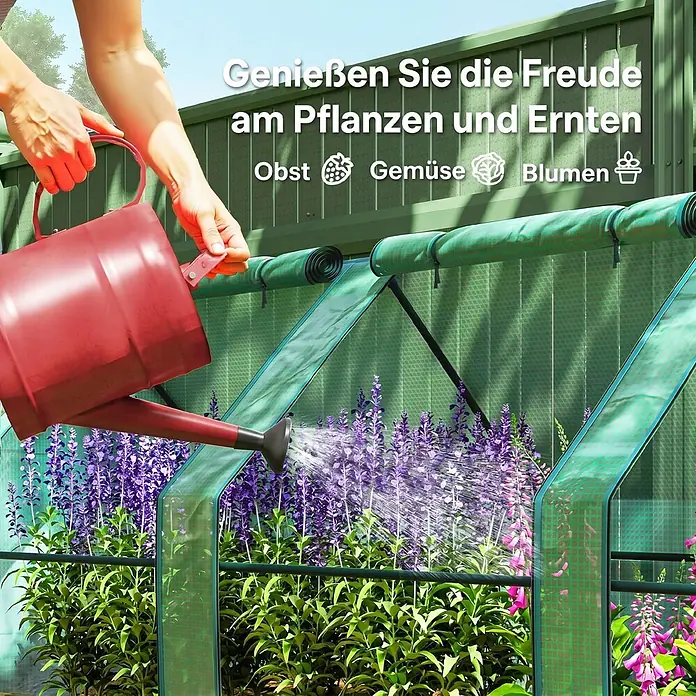 Outsunny Gewächshaus Grün 360L x 90B x 90H cm -  - Eine Person gießt Pflanzen in einem grünen Gewächshaus mit einer roten Gießkanne, was die Freude am Gärtnern hervorhebt.