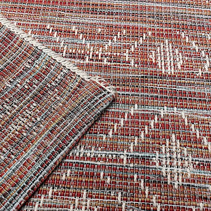 Dekoria Teppich Breeze sunset 155x230cm -  - Nahaufnahme eines mehrfarbigen Webteppichs, überwiegend rot und orange mit weißen und blauen Akzenten. Eine Ecke ist umgeschlagen, zeigt die Webart.