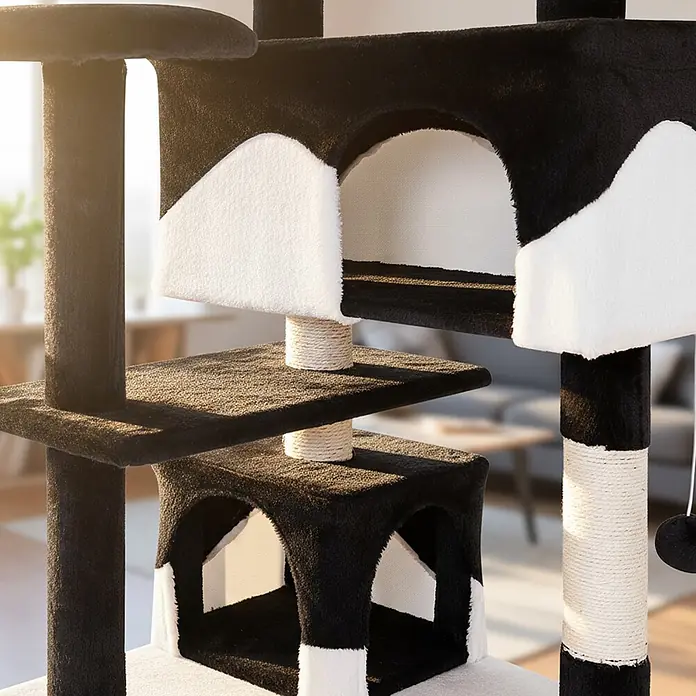belviona Kratzbaum 130 cm mit Höhlen, Treppe & Spielbällen, schwarz/weiß -  - Ein schwarz-weißer, mehrstöckiger Kratzbaum mit Sisalstämmen und Katzenhäusern, in einem hellen Innenraum.