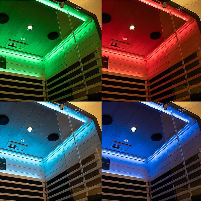 Home Deluxe Infrarotkabine NERO M Schwarz -  - Innenansicht einer Sauna mit Holzverkleidung und Glas, beleuchtet von farbwechselnden LED-Lichtstreifen in Grün, Rot, Hell- und Dunkelblau.
