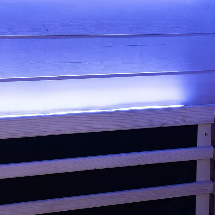 Home Deluxe Infrarotkabine NERO M Schwarz -  - Blaue LED-Lichtleiste hinter hellen Holzlamellen, die die Verkleidung akzentuiert beleuchtet.