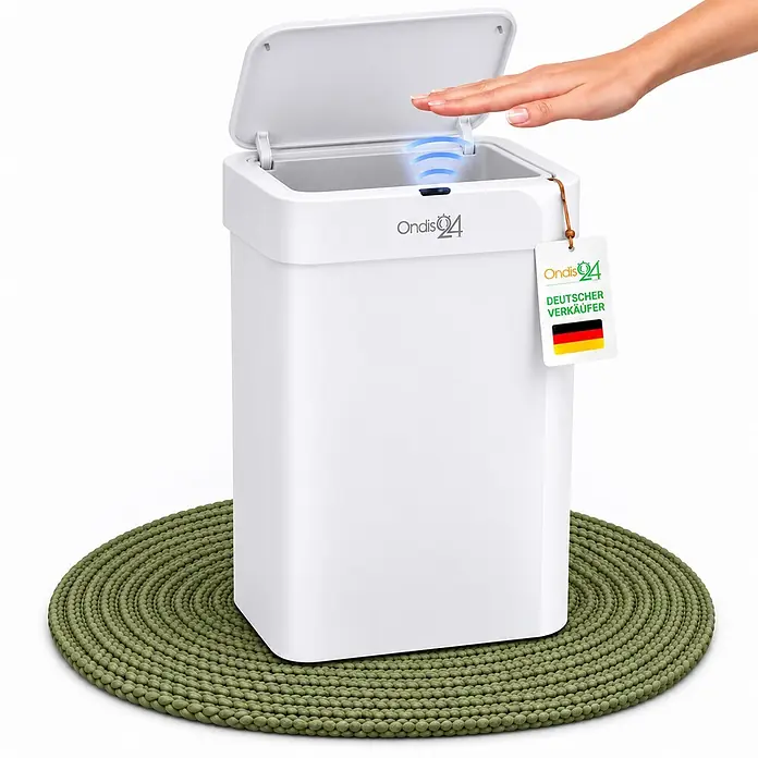 Ondis24 Sensormülleimer 50l Weiß, Kunststoff -  - Weißer Sensor-Mülleimer mit geöffnetem Deckel, Hand löst Sensor aus, auf grüner gewebter Matte.