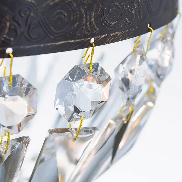 Orion Leuchten Kronleuchter Arila Ø 25 cm -  - Dunkle Metallzierleiste mit Goldakzenten, trägt klare facettierte Kristallanhänger an gelben Haken.