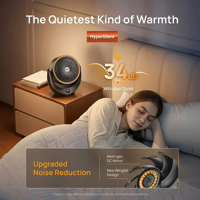 Dreo Calefactor cerámico 715 - 2.000 W, Negro, 19,3 x 28,9 x 33,3 cm - Un ventilador/calefactor negro y naranja silencioso en una mesita de noche junto a una mujer durmiendo, destacando su funcionamiento silencioso.