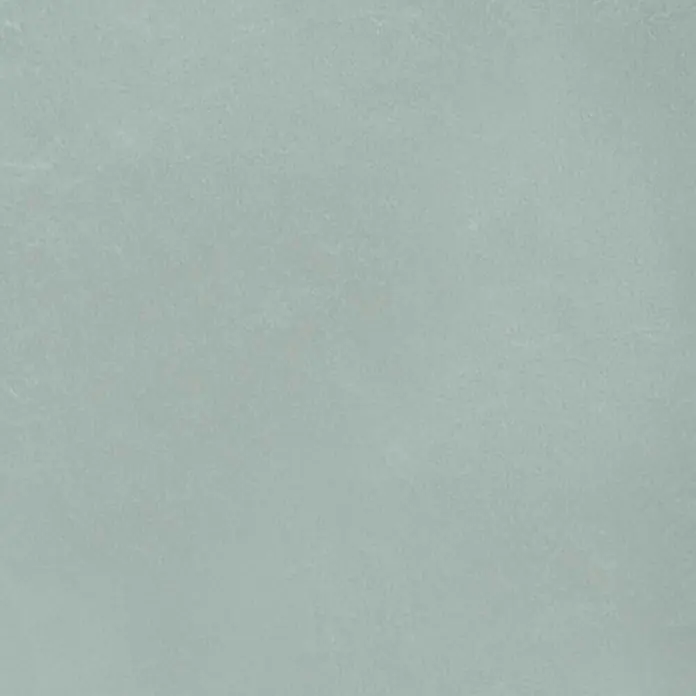 Feinsteinzeug in farbiger grüner pastellfarbener Betonoptik 60x60 -  - Weich texturierte Oberfläche in einem gedämpften Hellblau-Grün.