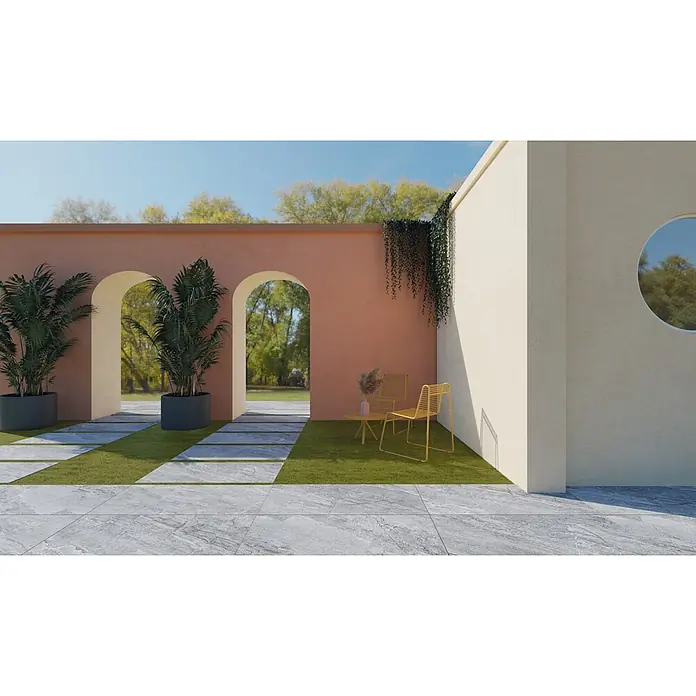 Feinsteinzeug in grauer Steinoptik 60x60, 20 mm, rutschhemmend -  - Stilvolle Außenterrasse mit grauem Fliesenweg, grünem Rasen, Terrakotta-Bögen und modernen gelben Möbeln unter klarem Himmel.
