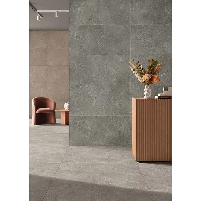 Feinsteinzeug in strukturierter grauer Betonoptik 80x80 - Ital. Fliesen -  - Graue Fliesen in Betonoptik an Boden und Wand eines modernen Raumes, ergänzt durch beige Wandfliesen.