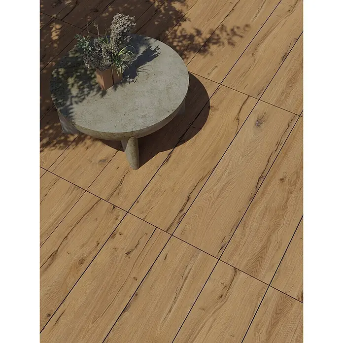 Feinsteinzeug in antiker Eichenholzoptik 20x120, rutschhemmend -  - Helle Holzoptik-Fliesen für den Außenbereich, mit Betontisch und Trockenpflanze in natürlicher Terrassenumgebung.